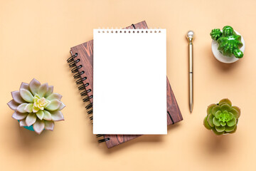 Notepad, home plant, calculator, pen on beige background Financial planning, goals, project for New Year concept Top view Flat lay Copy space Mock up