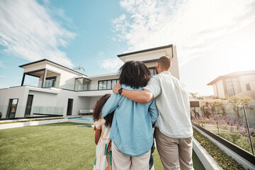 Love, new home and family standing in their backyard looking at their property or luxury real estate. Embrace, mortgage and parents with their children on grass at their house or mansion in Canada.