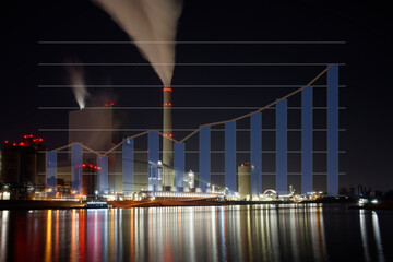 Coal-fired power plant at night with smoking chimney. The colorful lights are reflected in the...