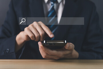 Businessman showing internet search on smartphone