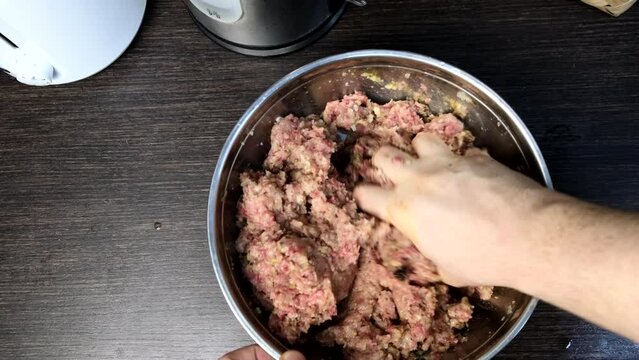 cooking meatballs mixing forcemeat overhead in bowl