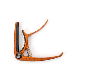 Metal capo for guitar with spring painted wood.