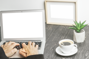 people sits on a work with a laptop computer for a wood table on the blackboard background
