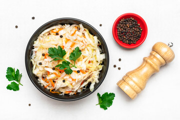 sour cabbage in wooden bowl pepper on white table Fermented vegetable concept Healthy food Top view