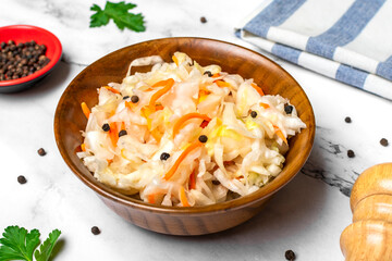 sour cabbage in wooden bowl pepper on white table Fermented vegetable concept Healthy food Top view