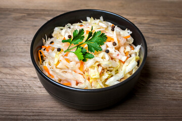 sour cabbage in wooden bowl pepper on table Fermented vegetable concept Healthy food Top view