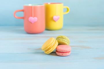 Macarons for Valentine's Day over blue wooden background.