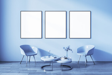 Front view on three blank white posters in black frame on sunlit wall background in light blur shades living room with coffee table among glossy chairs on wooden floor. 3D rendering, mock up