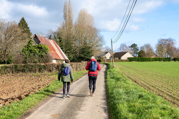 Couple de retraité effectuant une randonnée par beau temps sur une route de campagne