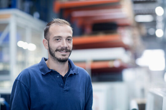 Confident store worker in warehouse, Freiburg im Breisgau, Baden-W&uuml;rttemberg, Germany