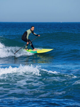 Man surfing with a stand up paddling board at sopelana beach