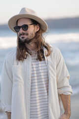 portrait of a man in a hat in varna bulgaria on the beach, model shooting , beach shooting 