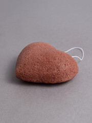 Natural konjac sponge for washing on gray background. Sponge in the form of heart