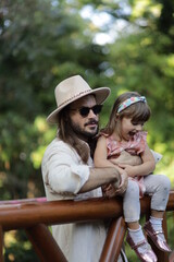 portrait of a man with her happy child in varna bulgaria sea garden, model shooting , beach shooting 