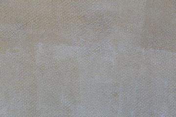 Rough textural surface of the wall, plastered for finishing. Backdrop for design, graphic resource. Texture background