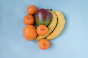 fruits and citrus in assortment on a blue background