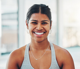 Fitness, happy and portrait of a woman in the gym after a workout for health and wellness. Happiness, smile and headshot of a female model athlete standing in a sport center for exercise or training.