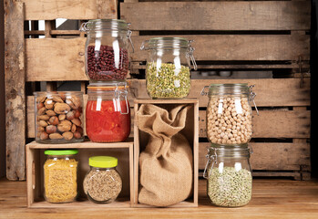 Canned tomatoes. Legumes. Glass canning jars, pantry. Storage in old wooden boxes. Natural and...