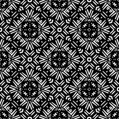 Fototapeta premium Vector geometric ornament in ethnic style. Seamless pattern with abstract shapes,Black and white color. Repeating pattern for decor, textile and fabric.