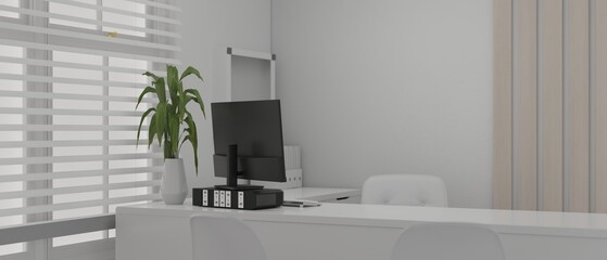 Modern white private office interior design with computer on a white desk against the window
