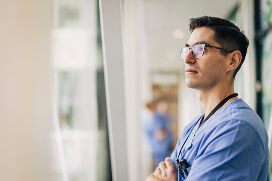 Mature male healthcare staff contemplating at hospital