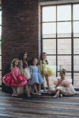 Fashion kids. Portrait of cute little kids in stylish clothes looking at the camera and smiling. Beautiful dress.