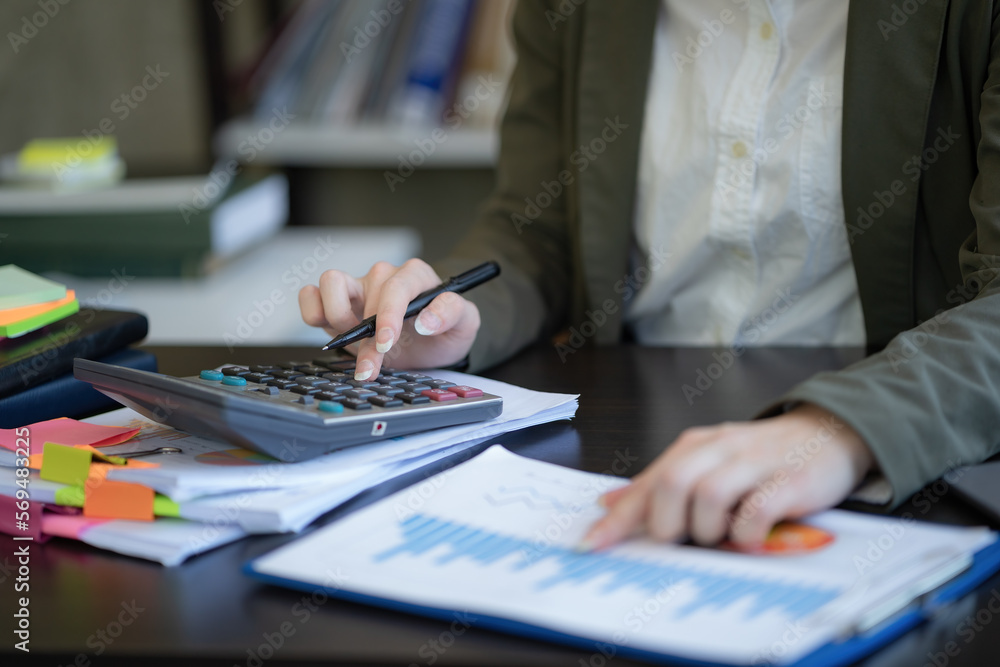 Poster close-up of businesswomen or accountants using calculator calculations while working on analytic bus