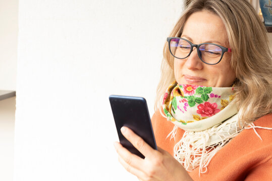 Smiling woman use smartphone and read news, send sms