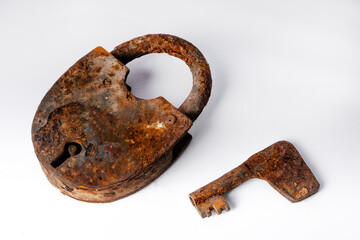 Old rusty lock with a key on a white background