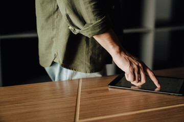 Close up of man's hands working on digital tablet