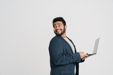 Cheerful indian guy holding laptop isolated over white background