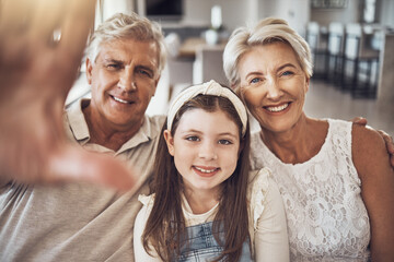 Selfie, portrait or happy grandparents with girl in living room bonding as a family in Australia with love. Pictures, smile or elderly man relaxing old woman with child at home together on holiday