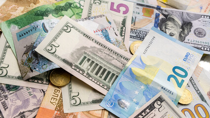 Background from different banknotes of dollars, euros, rubles, Belarusian rubles and other currency.