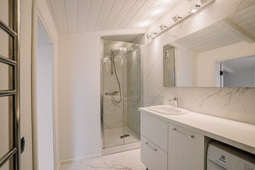 Fototapeta na wymiar Interior of white bathroom with bathtub and toiletries