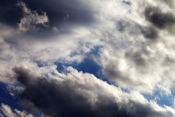 Blue sky with dark clouds