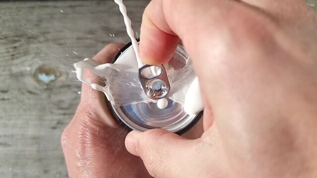 opening a beer can in slow motion