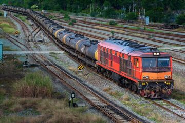 Tanker-freight train by diesel locomotive in the railway yard. 