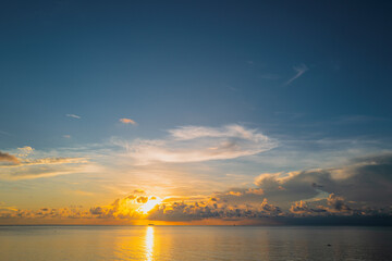 Naklejka premium Sunrise sea on tropical beach. Landscape of beautiful beach. Beautiful sunset at sea. Seascape in summer morning. Ocean sunset on sky background with colorful clouds.