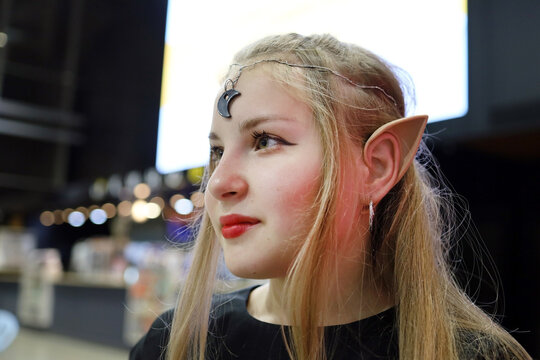 A teenage girl in the image of an elf at a movie night party