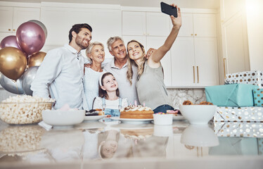 Birthday party, cake and family selfie in kitchen for happy memory, social media or profile picture. Love, food and girl, mother and grandparents taking pictures or photo together to celebrate event.