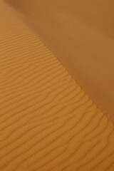 Abstract photograph of sand dunes shot at sunset in Merzouga, Morocco