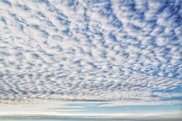 White light soft clouds floating in blue sky. Nature morning landscape background. Clear spring wind. Bright summer day. Winter calm air skyscape. Abstract panorama. Change climate. Low angle view