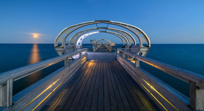 Illuminated pier on the Baltic Sea resort of Kellenhusen after sunset. View of Baltic sea resort Kellenhusen with its famous pier, Schleswig-Holstein, Germany. 
