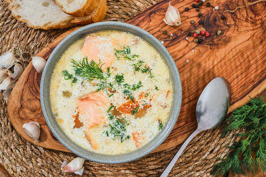 Salmon soup, creamy hearty Finnish salmon soup. Clean food, healthy and diet food. Top view, full plate of fish soup, best studio shot