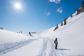 hiker at mountain trail Rofan alps in winter, austrian landscape