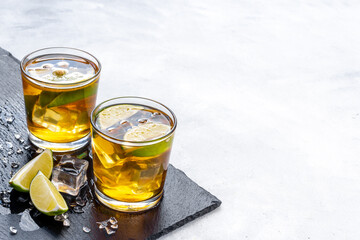 Alcoholic cocktails with oganges and ice in glasses. Alcoholic drinks background