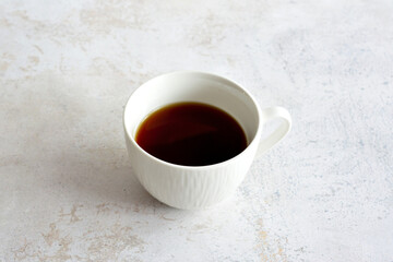 white cup of coffee isolated on marble background, close-up