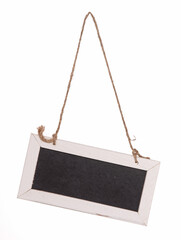 Wooden framed blackboard with chalk hanging at an angle