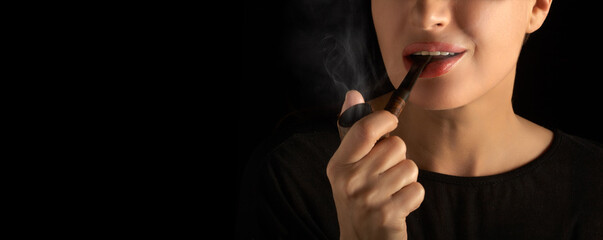 Woman smoking pipe. Smoking lady with a vintage wooden pipe. Cropped studio portrait isolated on...