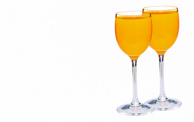 Two glasses of orange champagne isolated on white background with copy space.